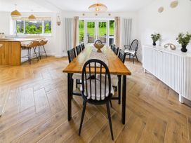 A dining room with a table and chairs at 59a Gwscwm Road