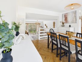 A dining room with a table and chairs at 59a Gwscwm Road