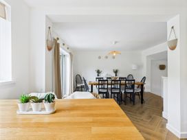 A dining room with a wooden table and chairs at 59a Gwscwm Road