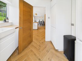 A kitchen with a sink and door at 59a Gwscwm Road