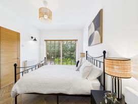 A bedroom with a bed and window at 59a Gwscwm Road