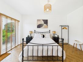 A bedroom with a bed and bedside table at 59a Gwscwm Road