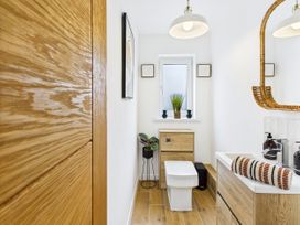 A bathroom with a toilet and sink at 59a Gwscwm Road