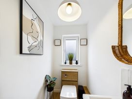 A bathroom featuring a toilet and sink at 59a Gwscwm Road