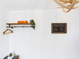 A shelf with basketballs and a plant in a room at 59a Gwscwm Road