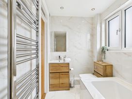 A bathroom with a sink and a bath tub at 59a Gwscwm Road