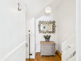 A hallway with a dresser and mirror at 59a Gwscwm Road