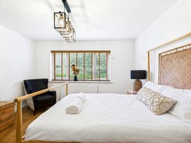 A bedroom with a bed, chair and window at 59a Gwscwm Road