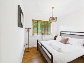 A bedroom with a bed and window at 59a Gwscwm Road