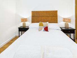 A bedroom with a bed and bedside tables at 59a Gwscwm Road