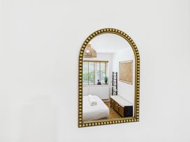 A view of a bedroom reflected in a mirror at 59a Gwscwm Road