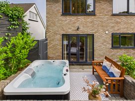 A garden with a hot tub and outdoor seating at 59a Gwscwm Road