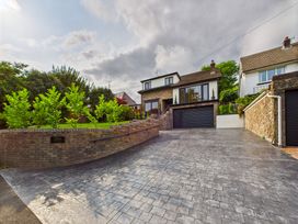 A house with a driveway and garden at 59a Gwscwm Road