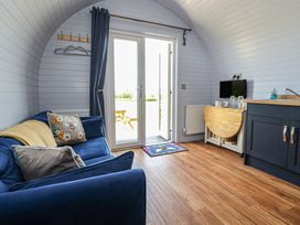 A living room with a sofa and television at Honeypot Hideaways - Manuka