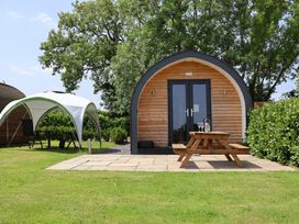 An outdoor area with a pod and seating at Honeypot Hideaways - Manuka
