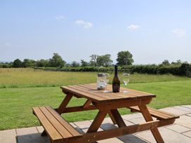 A picnic table with drinks in a field at Honeypot Hideaways - Manuka