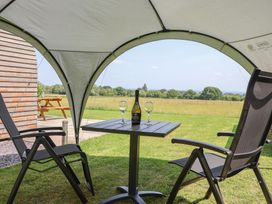 A table with a bottle and glasses under a tent at Honeypot Hideaways - Manuka