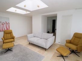 A living room with a sofa and armchairs at The Cottage in Ballinagleira