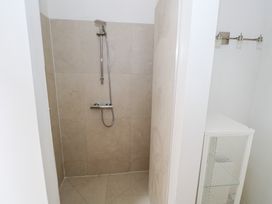 A shower with a storage cabinet at The Cottage in Ballinagleira