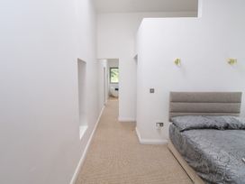 A bedroom with a bed and doorway at The Cottage in Ballinagleira