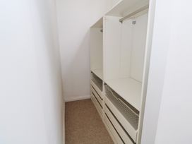 A closet with shelves and drawers at The Cottage in Ballinagleira