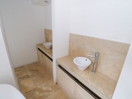 A bathroom with sinks and faucets at The Cottage in Ballinagleira