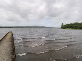 A water body with a pier and trees at The Cottage in Ballinagleira
