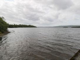 A lake view with trees along the shoreline at The Cottage in Ballinagleira