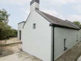 A side view of a house with a roof and windows at The Cottage in Ballinagleira