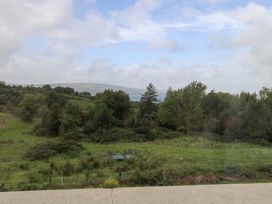 A landscape view with trees and water at The Cottage in Ballinagleira