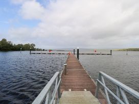A pier extending into water with buoys at The Cottage in Ballinagleira