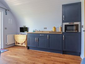A kitchen with a sink and microwave at Honeypot Hideaways - Clover