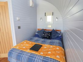 A bedroom with a bed and window at Honeypot Hideaways - Clover