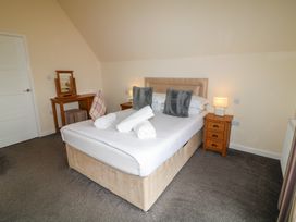 A bedroom with a bed and bedside table at Lodge 8 in Brigg