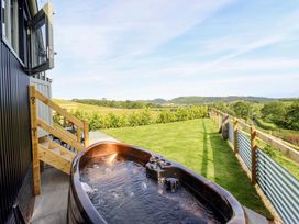 An outdoor area with a hot tub and grass at Charollais in Oswestry