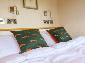 A bedroom with a bed and pillows at Charollais in Oswestry