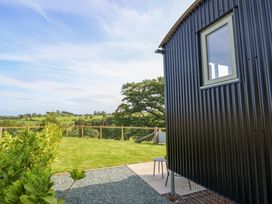 A garden with a shed and chair at Charollais in Oswestry