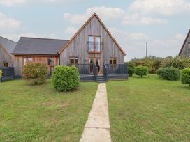 A house with a pathway and greenery at Lodge 9 in Brigg