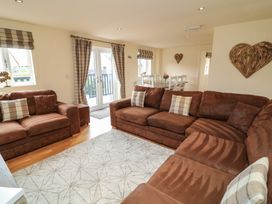 A living room with a sofa and dining area at Lodge 9 in Brigg