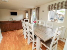 A dining room with a table and chairs at Lodge 9 in Brigg