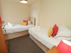A bedroom with two single beds and a dresser at Lodge 9 in Brigg