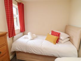 A bedroom with a bed and window at Lodge 9 in Brigg