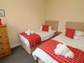 A bedroom with two beds and a dresser at Lodge 9 in Brigg