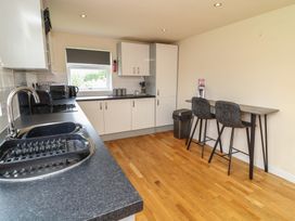 A kitchen with sink and table at Lodge 9 in Brigg