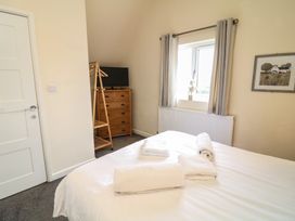 A bedroom with a bed and dresser at Lodge 9, Brigg