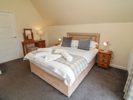 A bedroom with a bed and bedside tables at Lodge 9 in Brigg