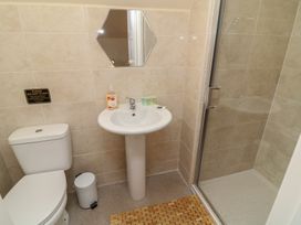 A bathroom with a toilet, sink, and shower at Lodge 9 Brigg