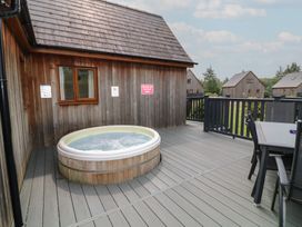 An outdoor area with a hot tub and seating at Lodge 9 in Brigg