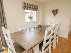 A dining room with a table and chairs at Lodge 13 in Brigg