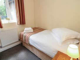 A bedroom with a single bed and window at Lodge 13 Brigg